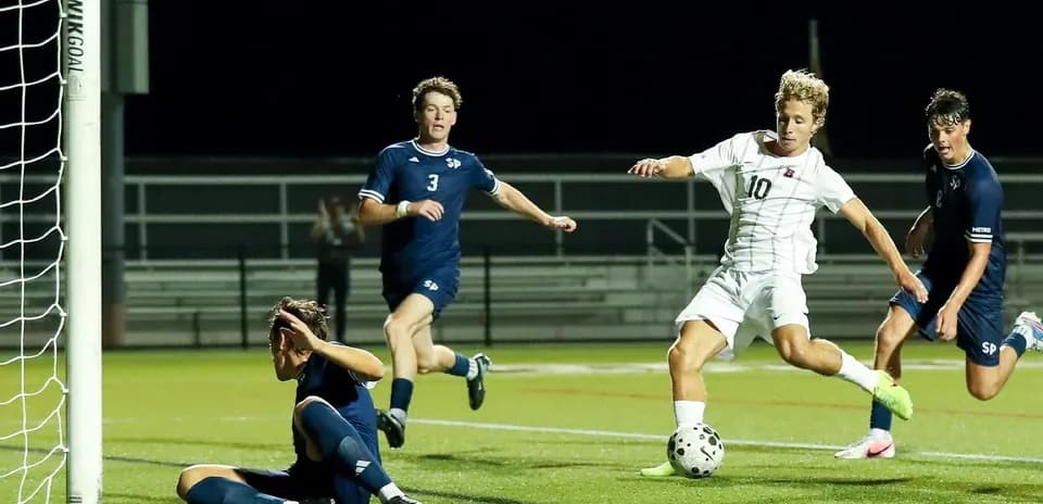 Player shooting on goal during soccer match