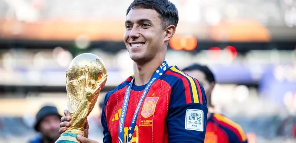 Player holding FIFA World Cup trophy in celebration
