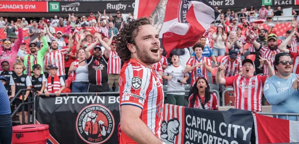Player celebrating with fans during football match