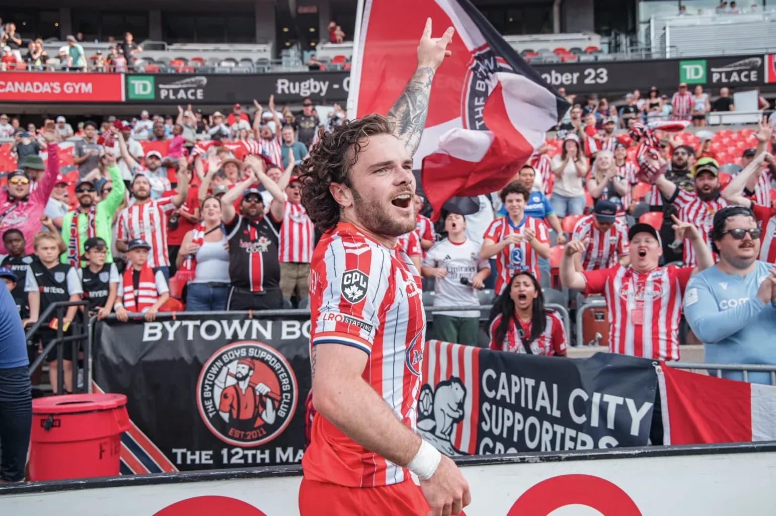 Player celebrating with fans during football match