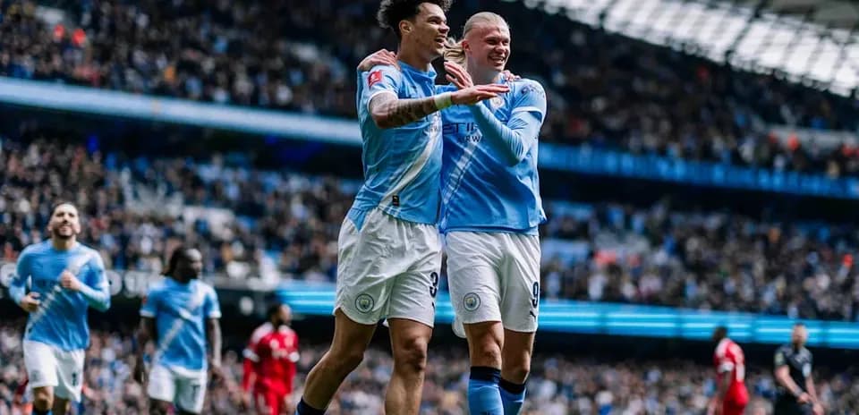Manchester City players celebrating a goal on field