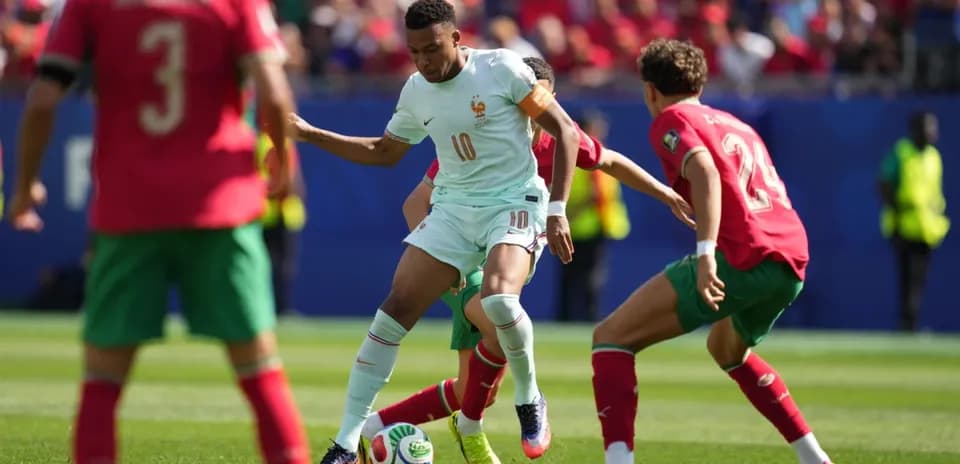 Player dribbling the ball during match between France and Morocco