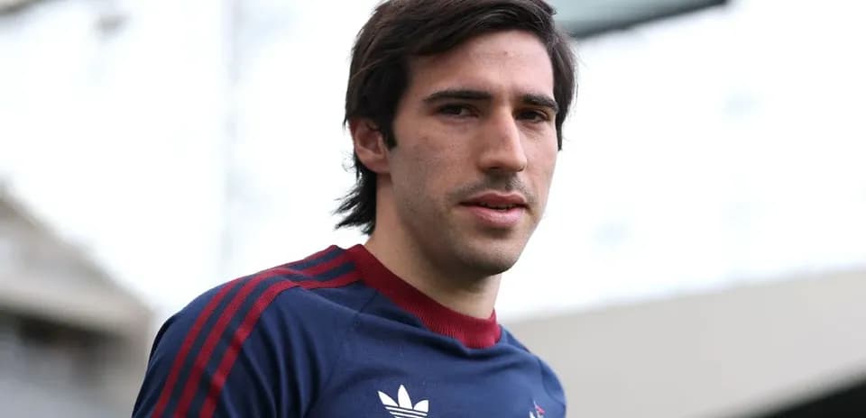 Player posing in team training kit at stadium