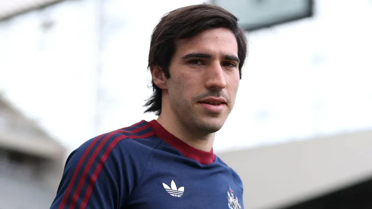Player posing in team training kit at stadium