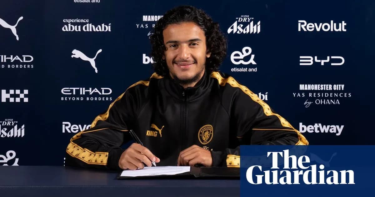 Player signing contract at Manchester City press event