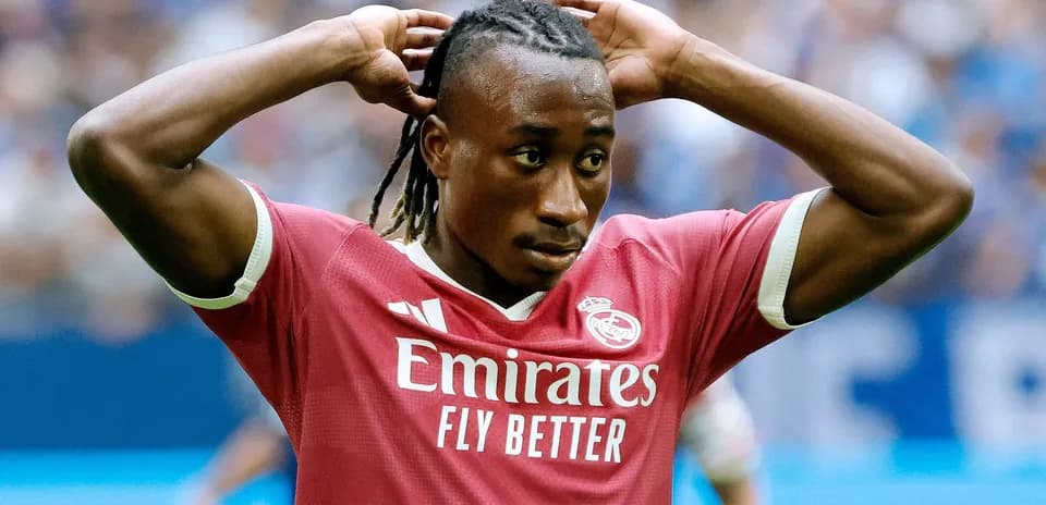 Player adjusting hair during football match