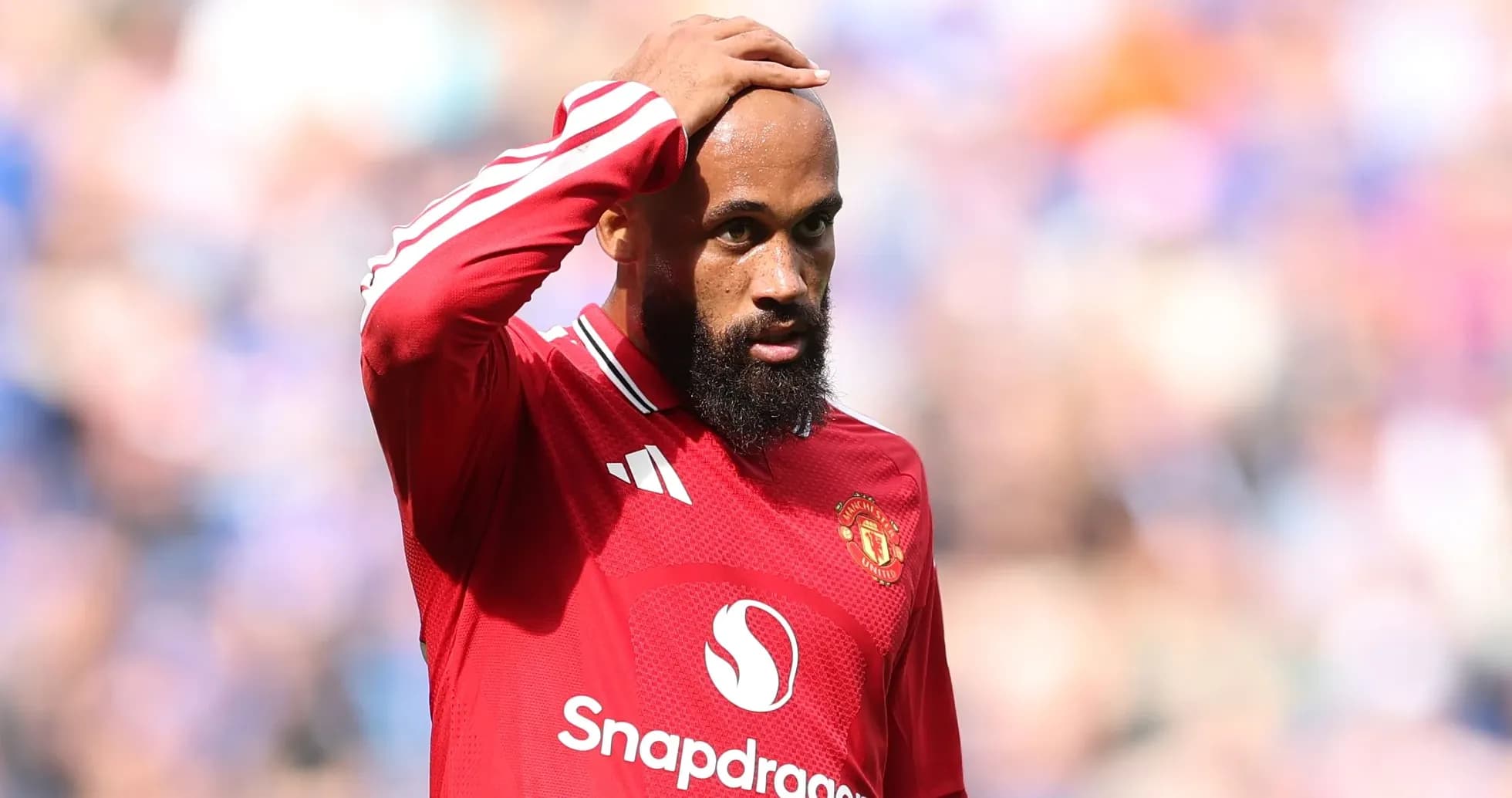 Player in red jersey looks concerned during match