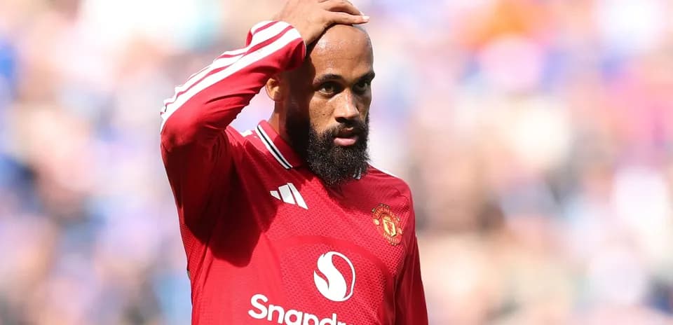 Player in red jersey looks concerned during match