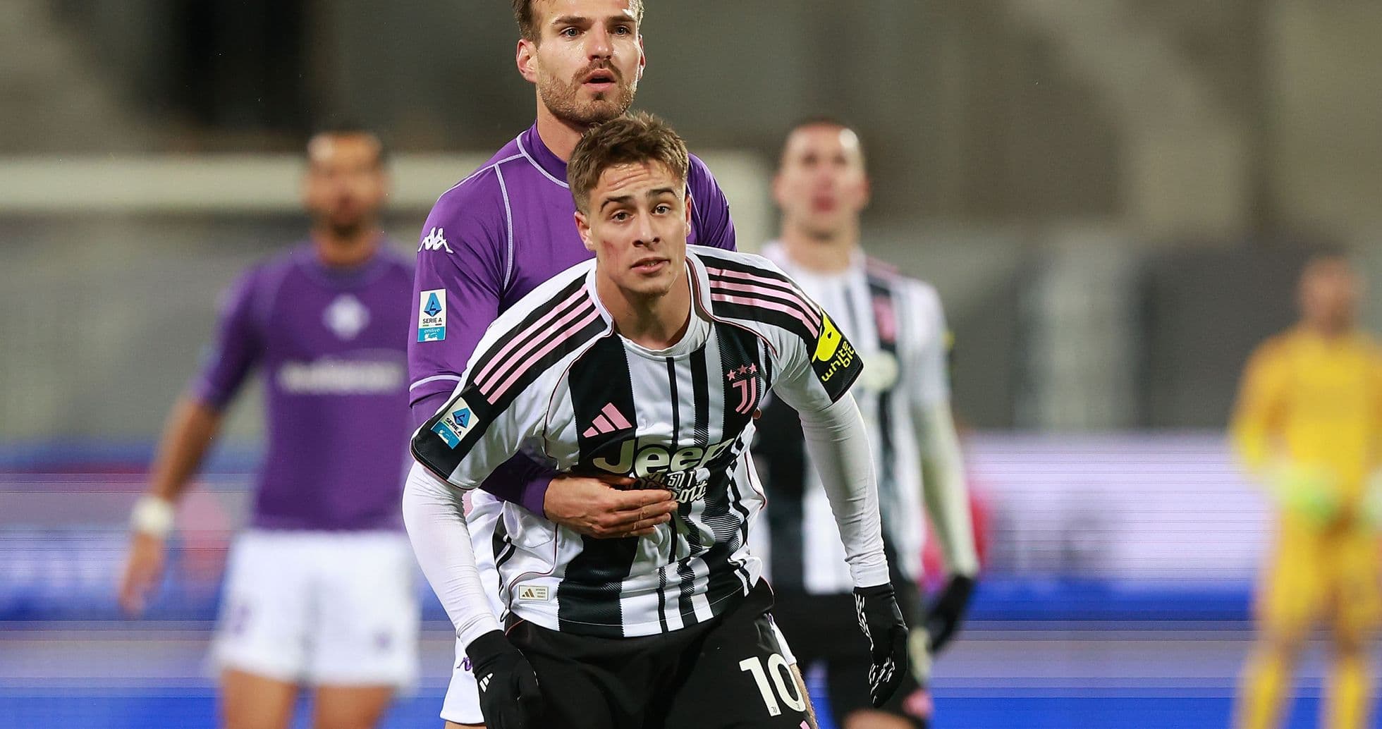 Juventus player engaged with Fiorentina opponent