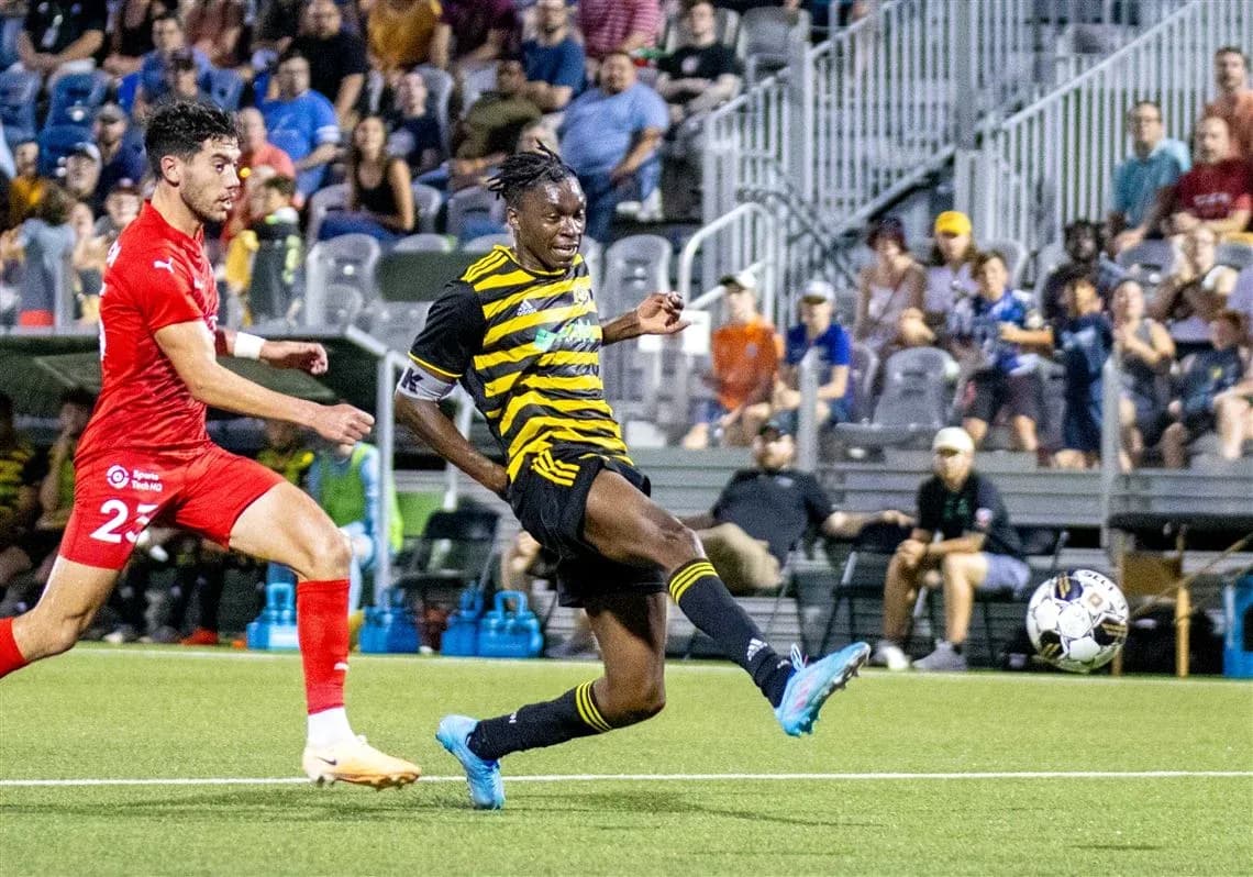Player kicking ball during Pittsburgh Riverhounds match