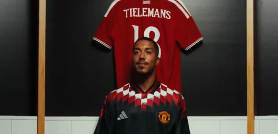 Player in Manchester United jersey with red shirt behind