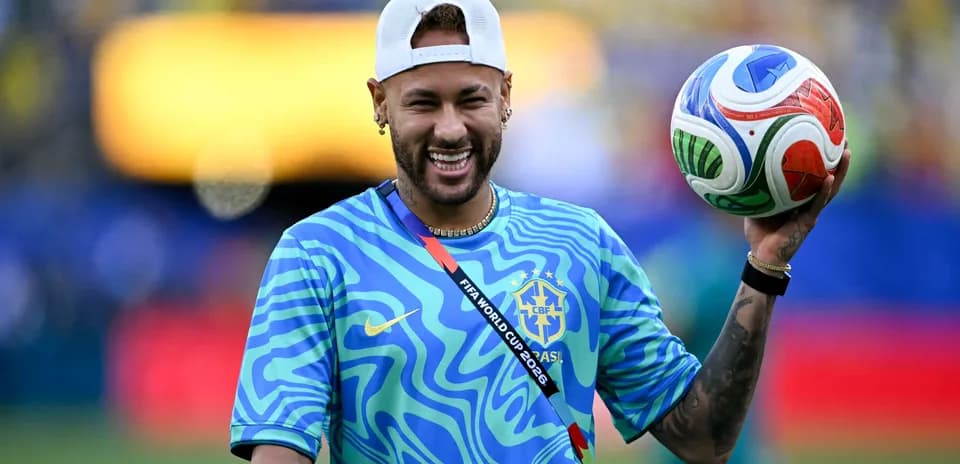 Player holding a soccer ball in warm-up attire