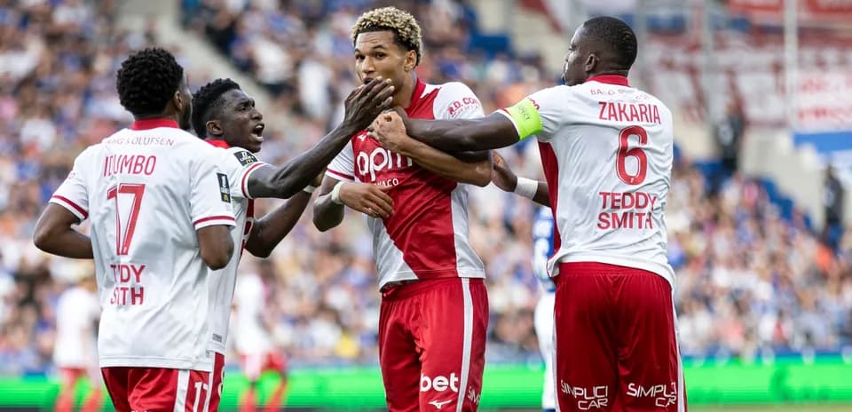 Players celebrating a goal on the field