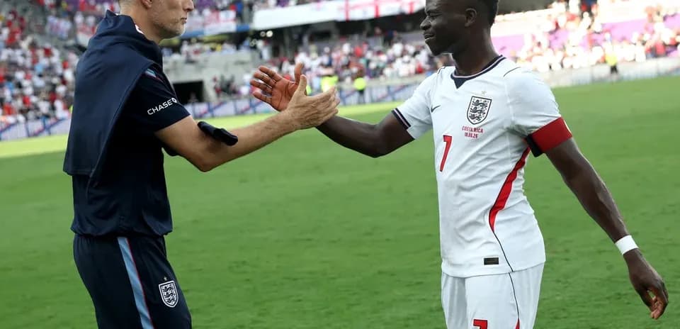 Coach and player exchanging handshake on field