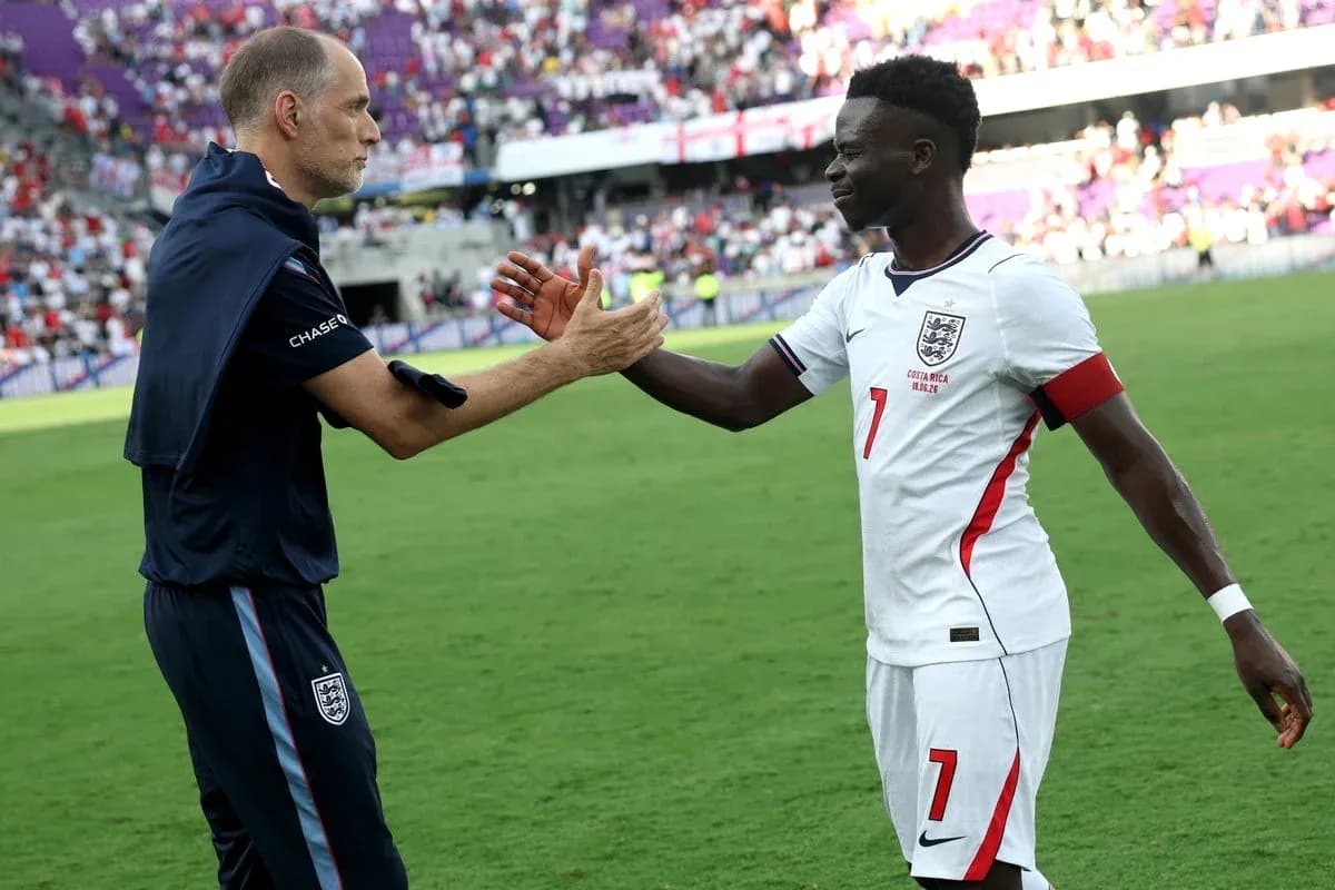 Coach and player exchanging handshake on field