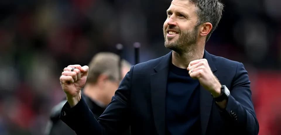 Coach celebrating enthusiastically on the pitch