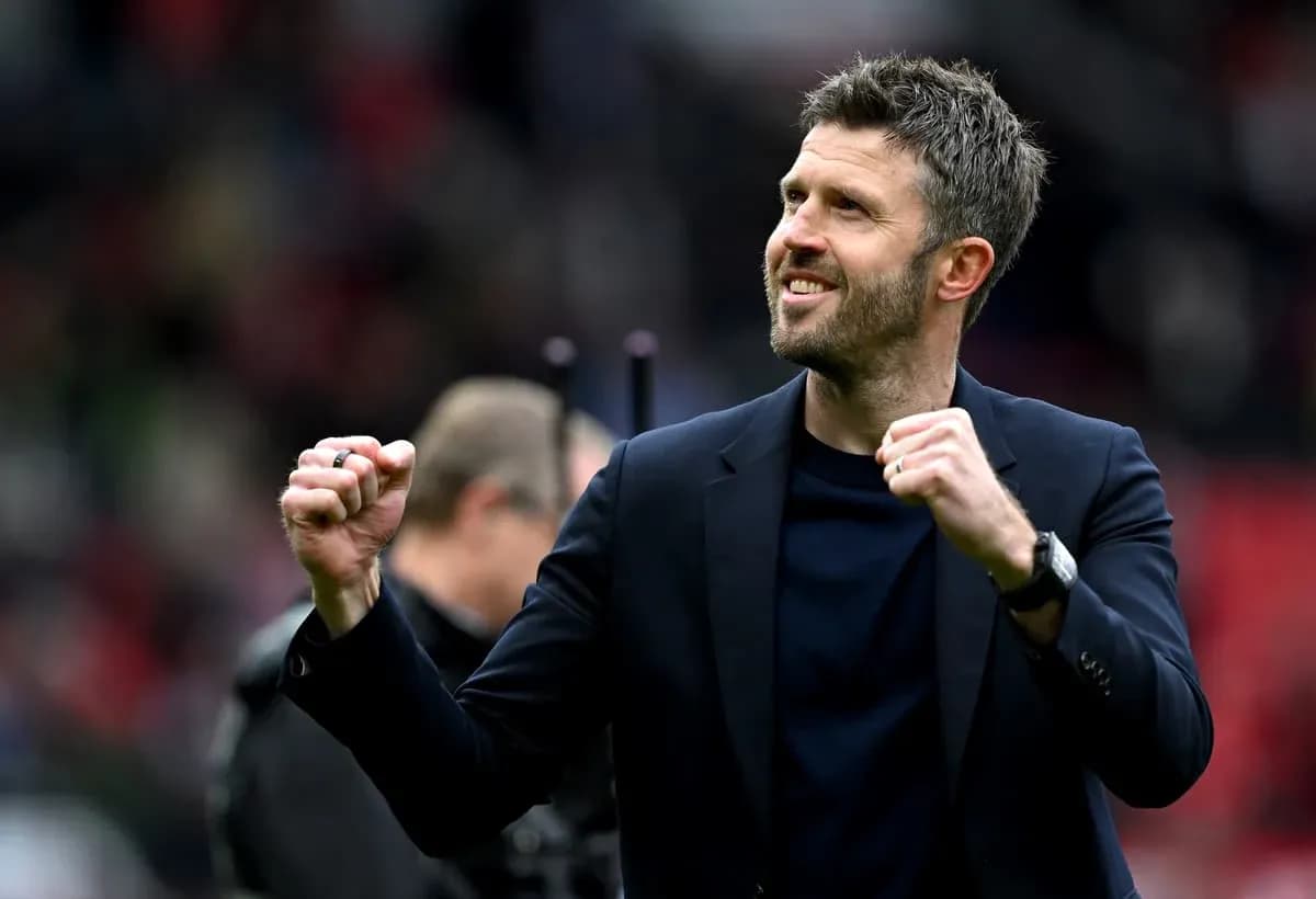 Coach celebrating enthusiastically on the pitch