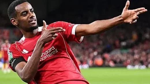 Player celebrating goal with hand gesture on pitch