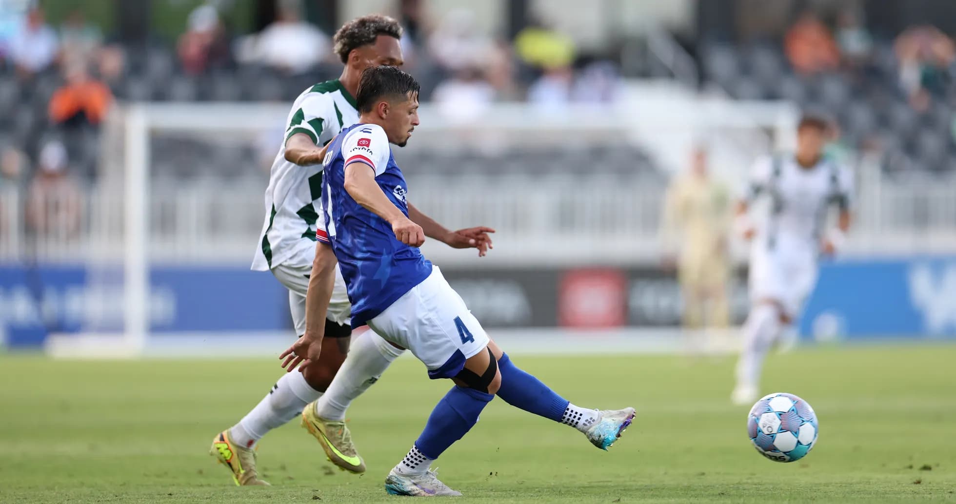 Player tackling opponent during USL Championship match
