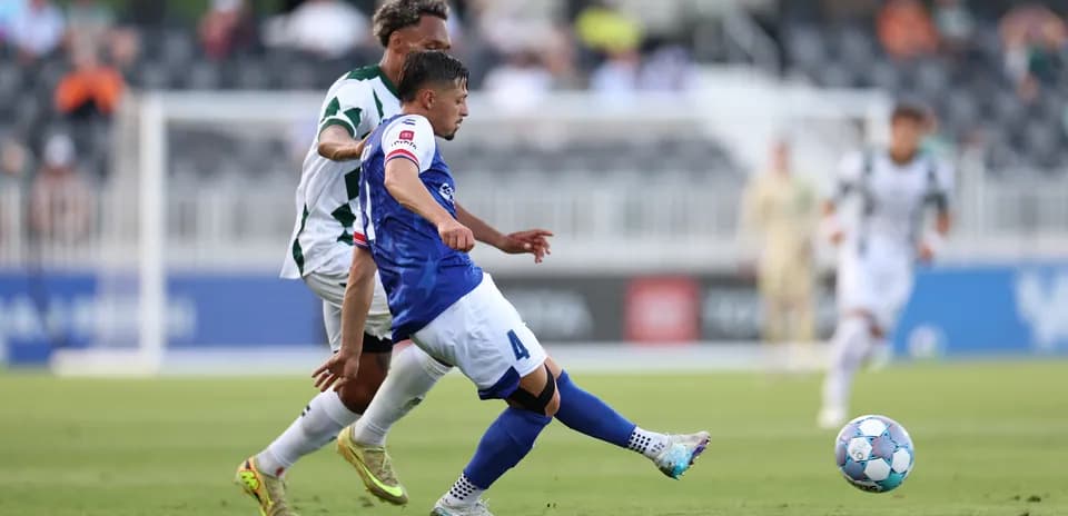 Player tackling opponent during USL Championship match