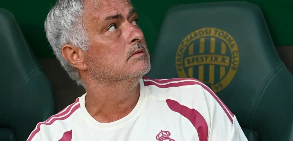 Coach observing from the bench during match