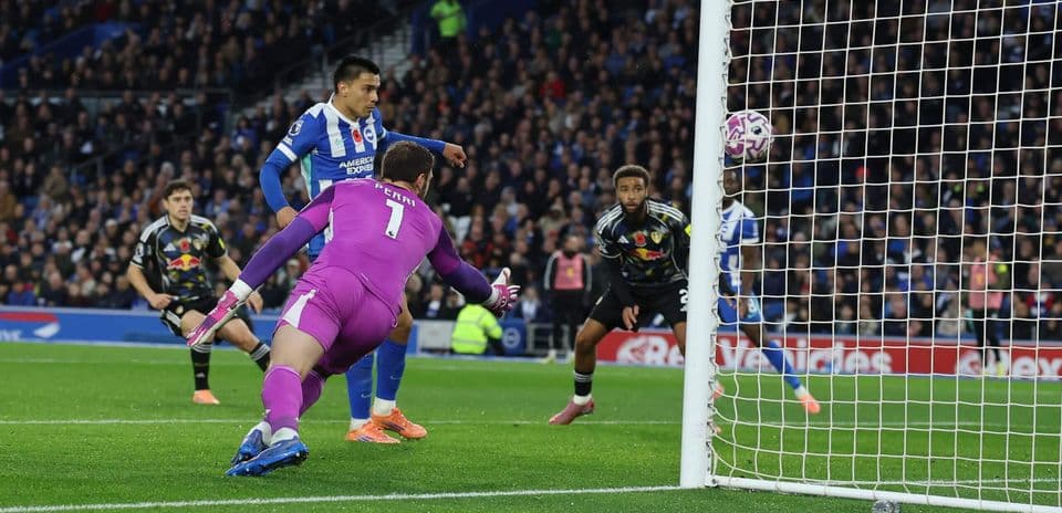 Brighton player scoring against Leeds goalkeeper