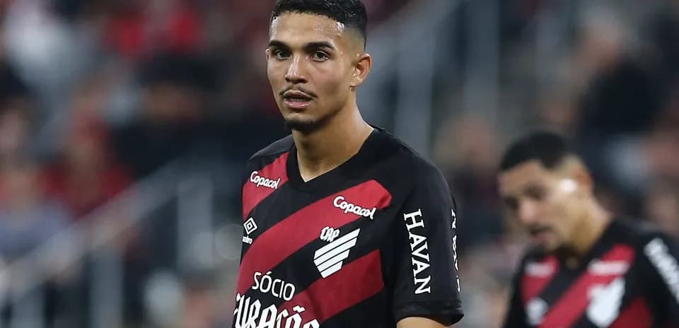 Player in black and red jersey on field