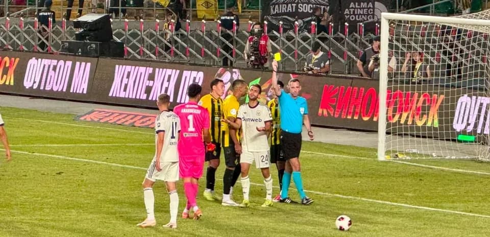 Players discussing after yellow card shown