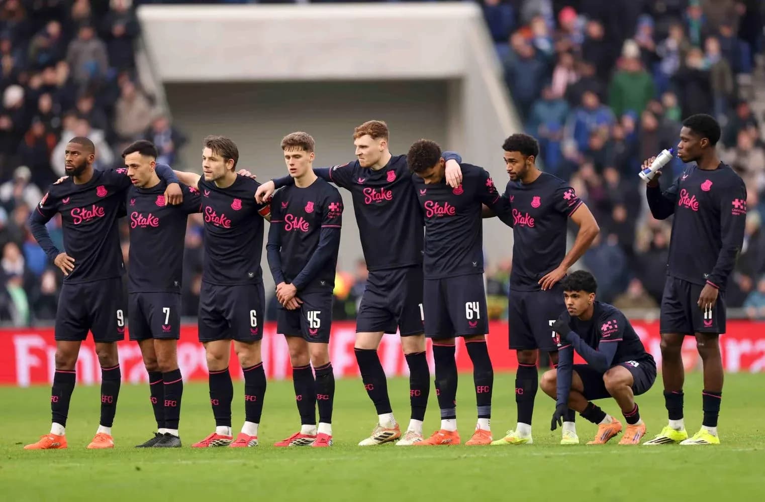 Everton players during a moment of reflection