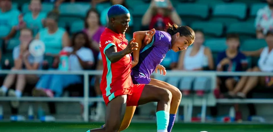 Kansas City player challenging Orlando Pride opponent