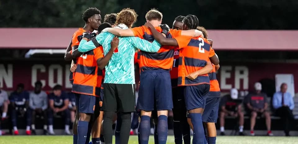 Soccer team huddled together before a match