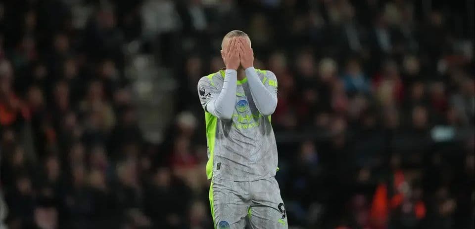 Goalkeeper covering face during intense match moment