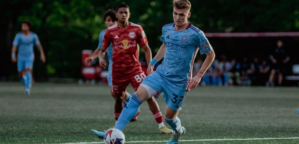 New York RB II player defending against NYC II