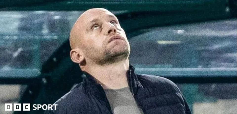 Coach looking up during a match from the sidelines