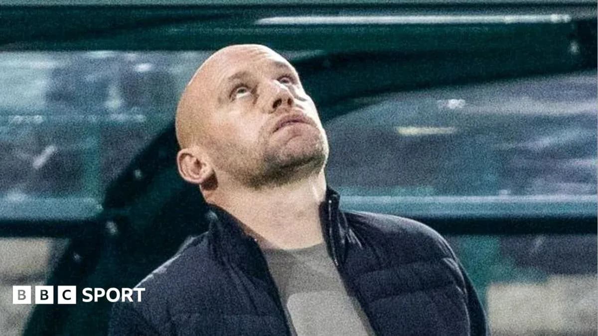 Coach looking up during a match from the sidelines