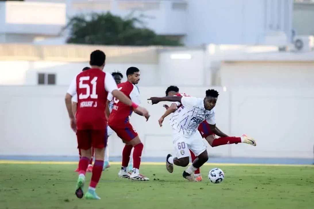 Al Ain U23 player dribbling past Al Sharjah U23 defenders