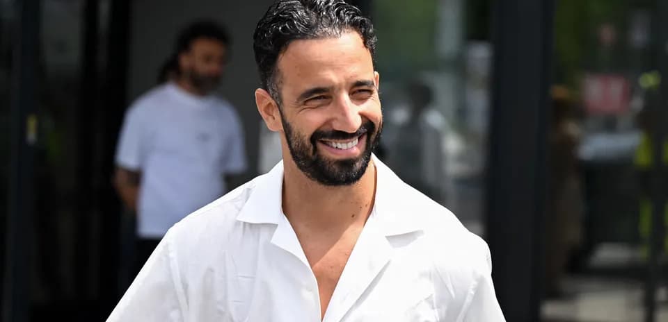 Man smiling while walking outside a building