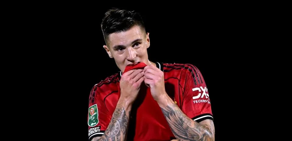 Player in red jersey holding shirt to mouth