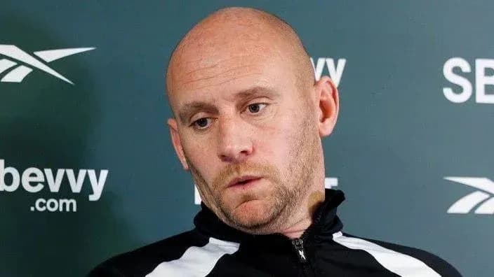Coach speaking during a press conference