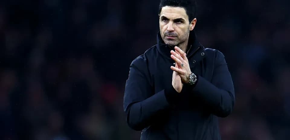 Manager applauding the crowd during a match