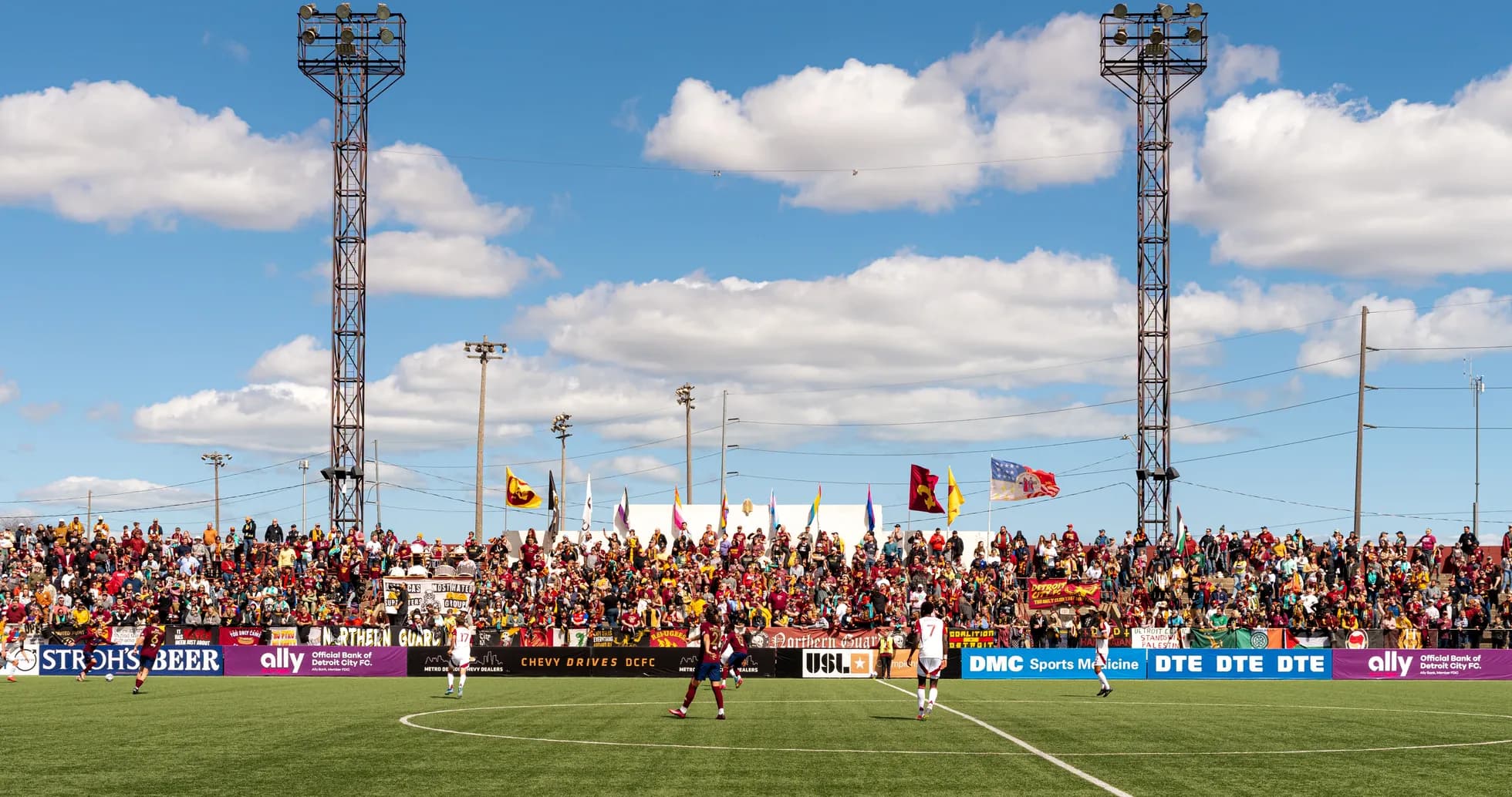 Crowd at Detroit City FC match with flags
