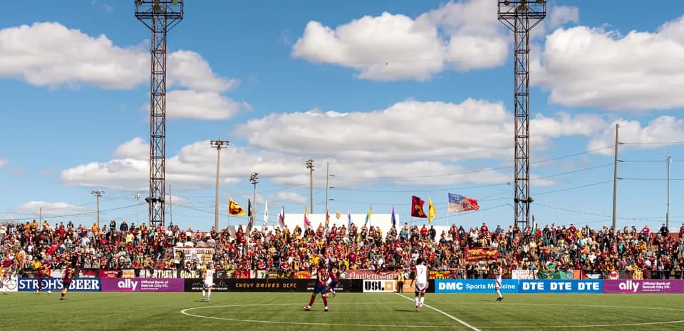 Crowd at Detroit City FC match with flags