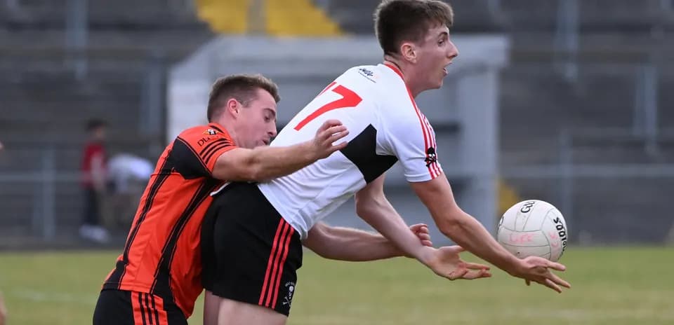 Two players competing for a football during match