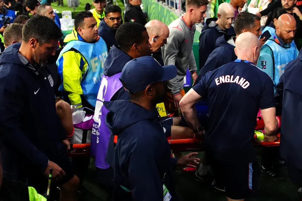 Medical staff assisting injured player off the field