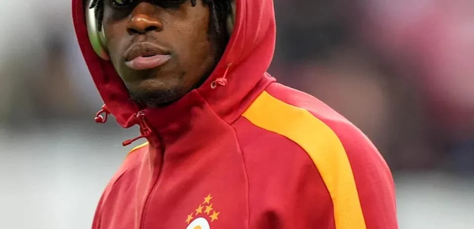 Player wearing red hoodie with club logo