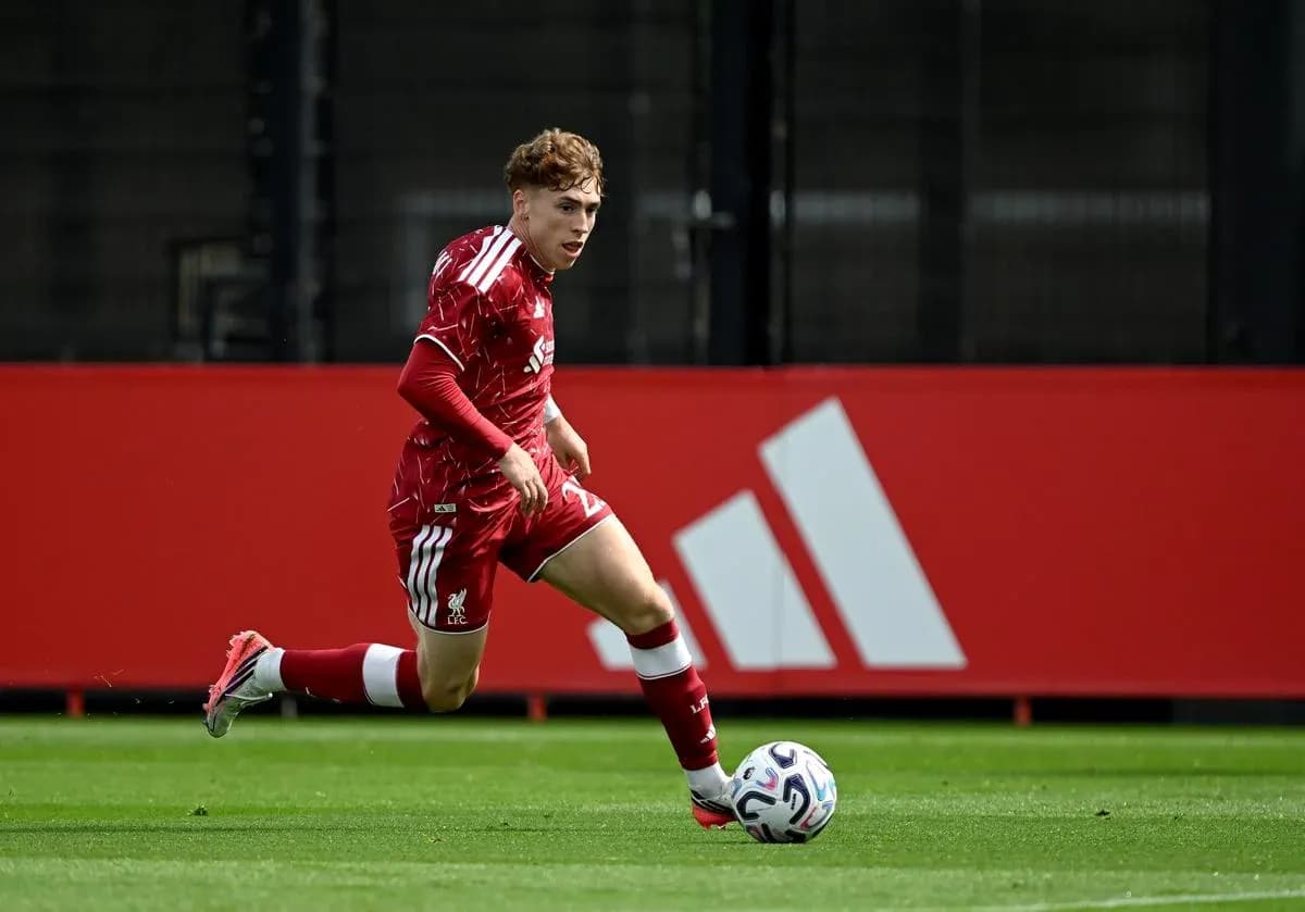 Player in red kit running with soccer ball