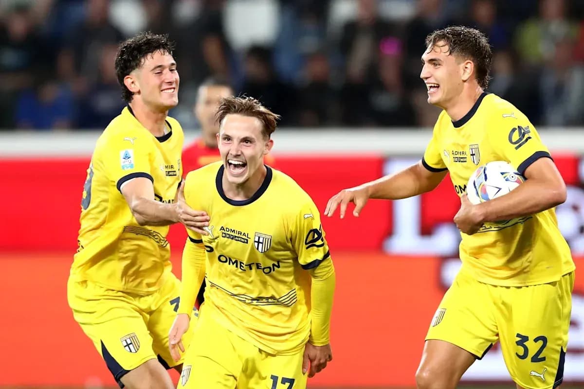 Three players celebrating a goal in yellow jerseys
