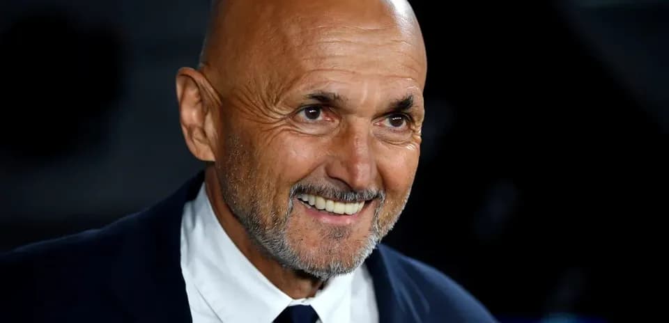 Smiling coach in a suit at an event