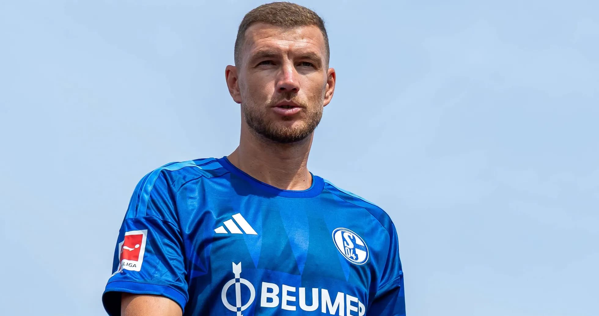 Player in blue Schalke jersey during outdoor event