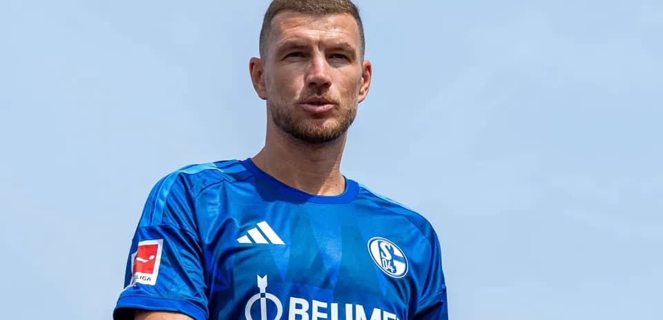 Player in blue Schalke jersey during outdoor event